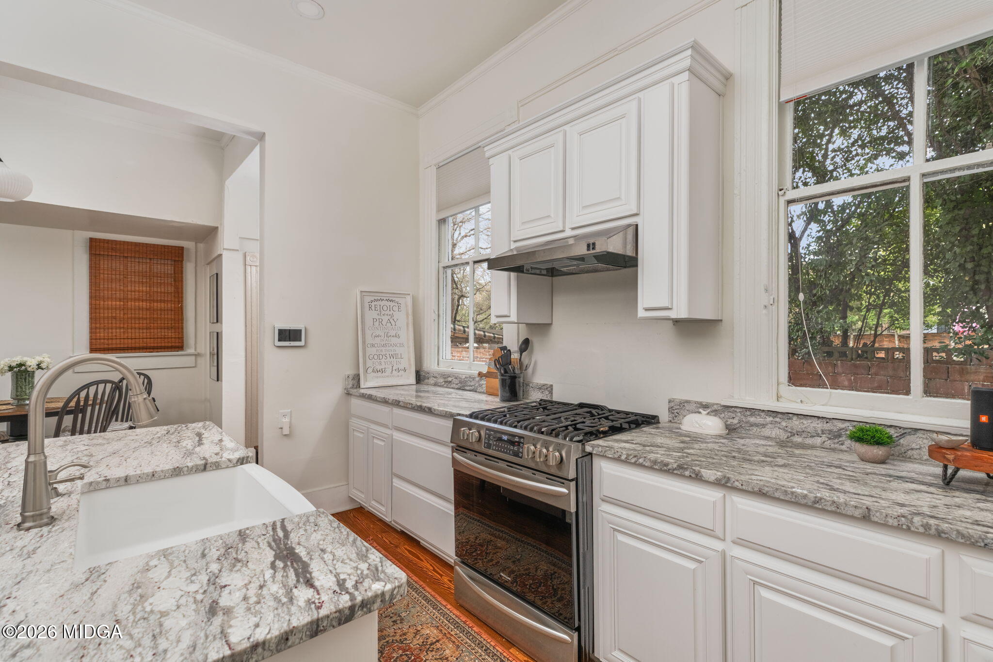 417 Orange Street Macon, GA 31201 - Photo 17 of 49 a kitchen with granite countertop a sink stove and cabinets