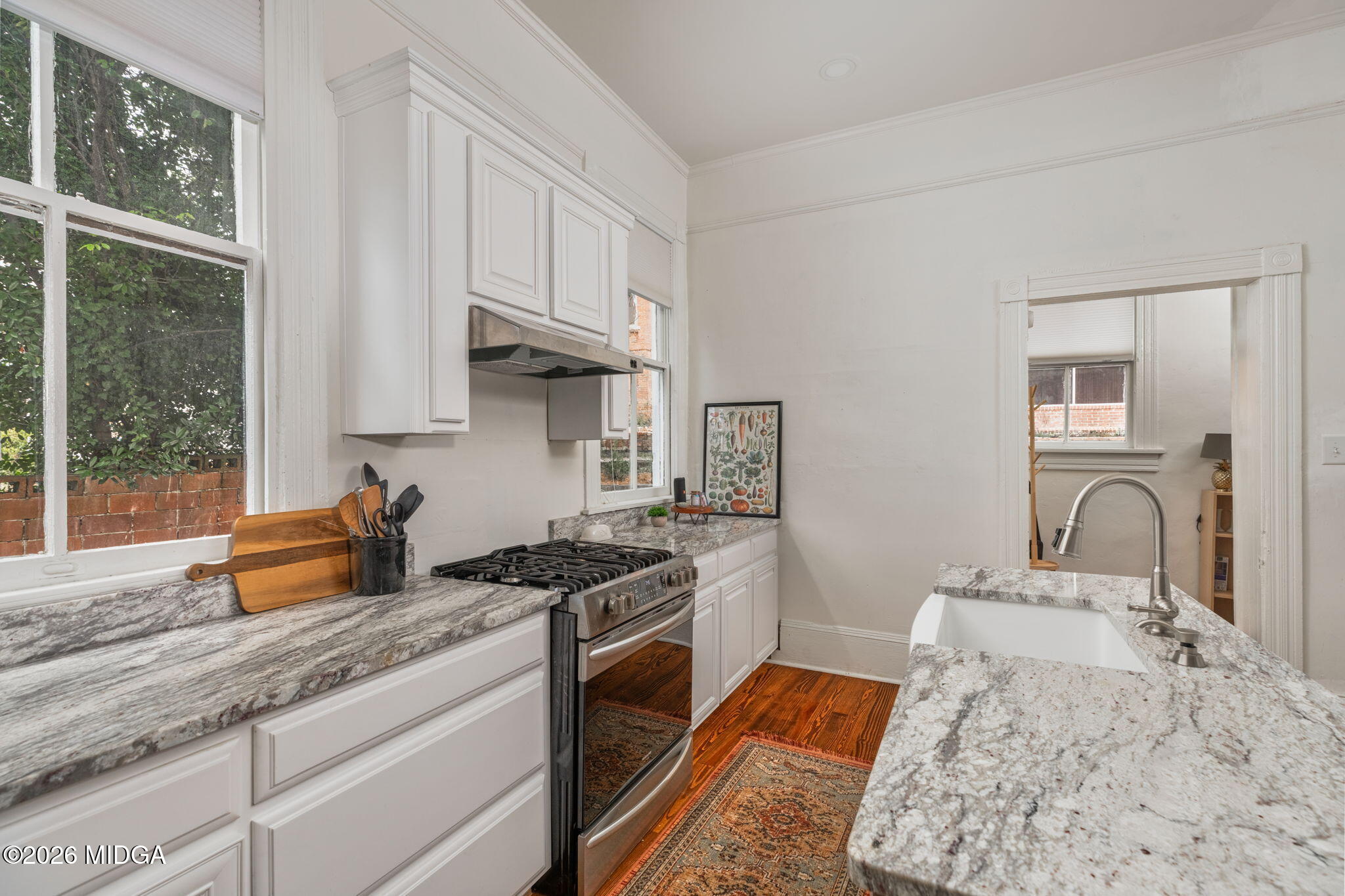 417 Orange Street Macon, GA 31201 - Photo 21 of 49 a kitchen with stainless steel appliances granite countertop a stove a sink and a granite counter tops with white cabinets