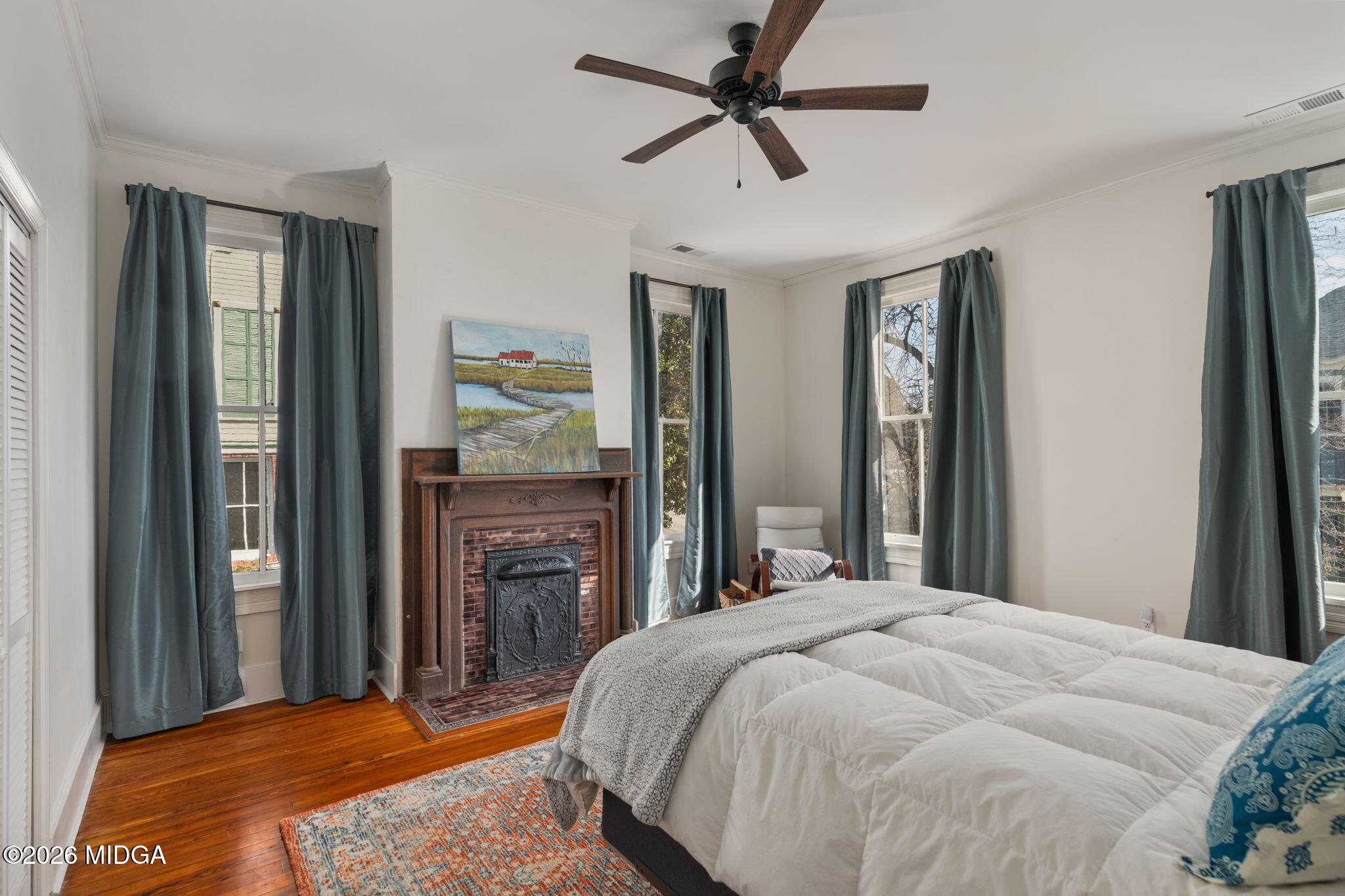 417 Orange Street Macon, GA 31201 - Photo 28 of 49 a bedroom with a bed and a chandelier