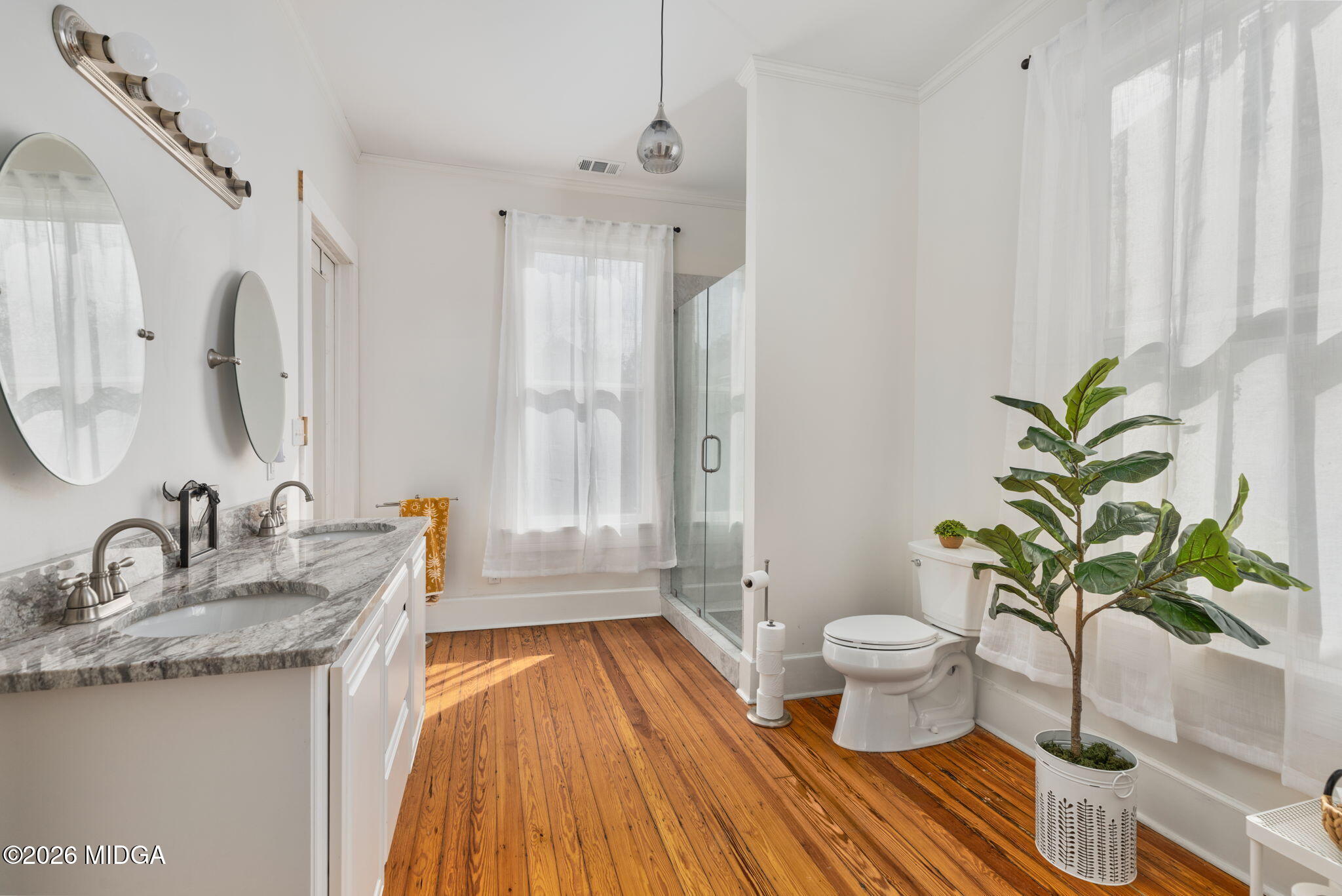 417 Orange Street Macon, GA 31201 - Photo 31 of 49 a bathroom with a granite countertop sink a toilet a mirror and shower