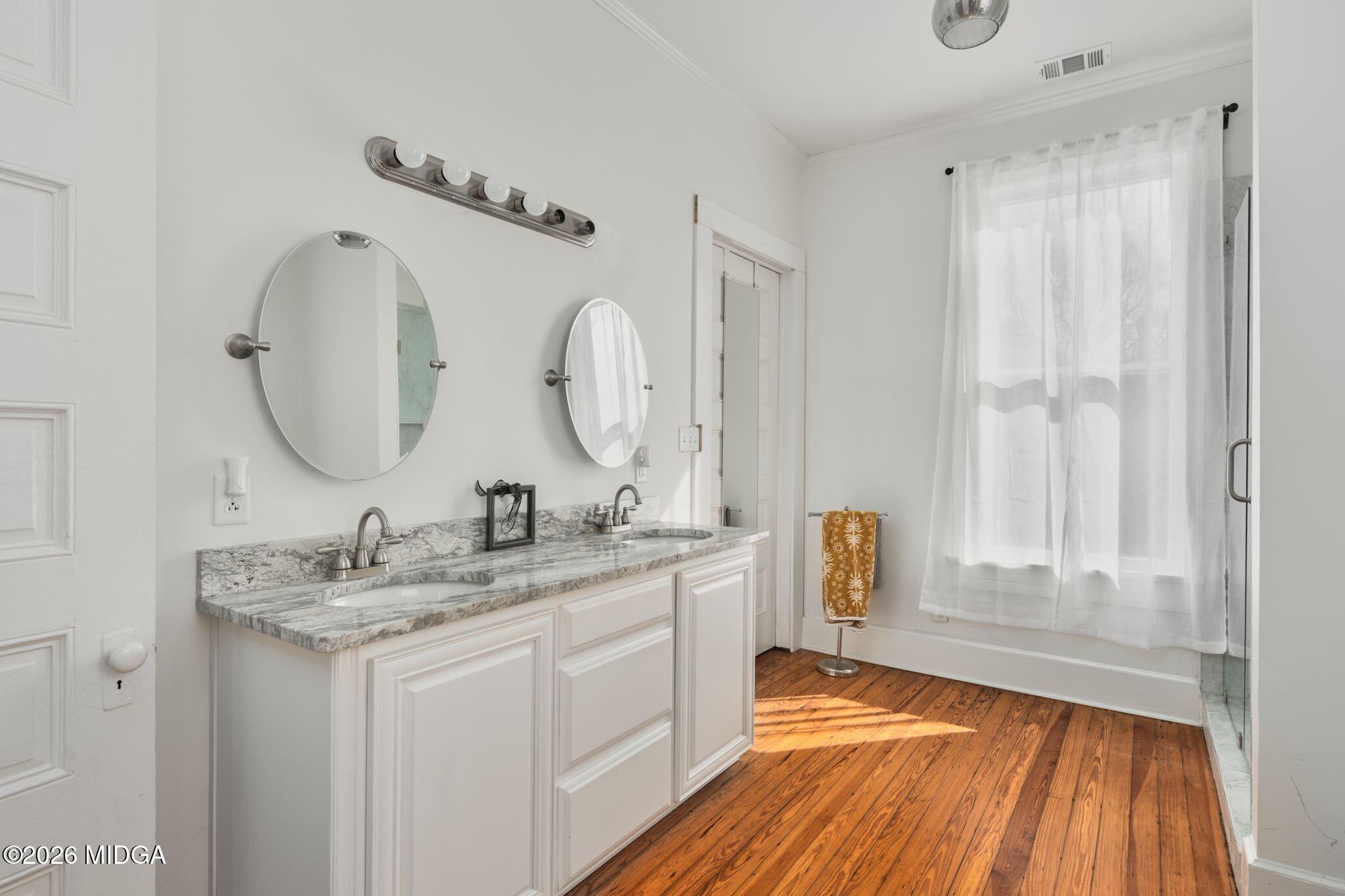 417 Orange Street Macon, GA 31201 - Photo 32 of 49 a en suite bathroom with a granite countertop sink and a mirror