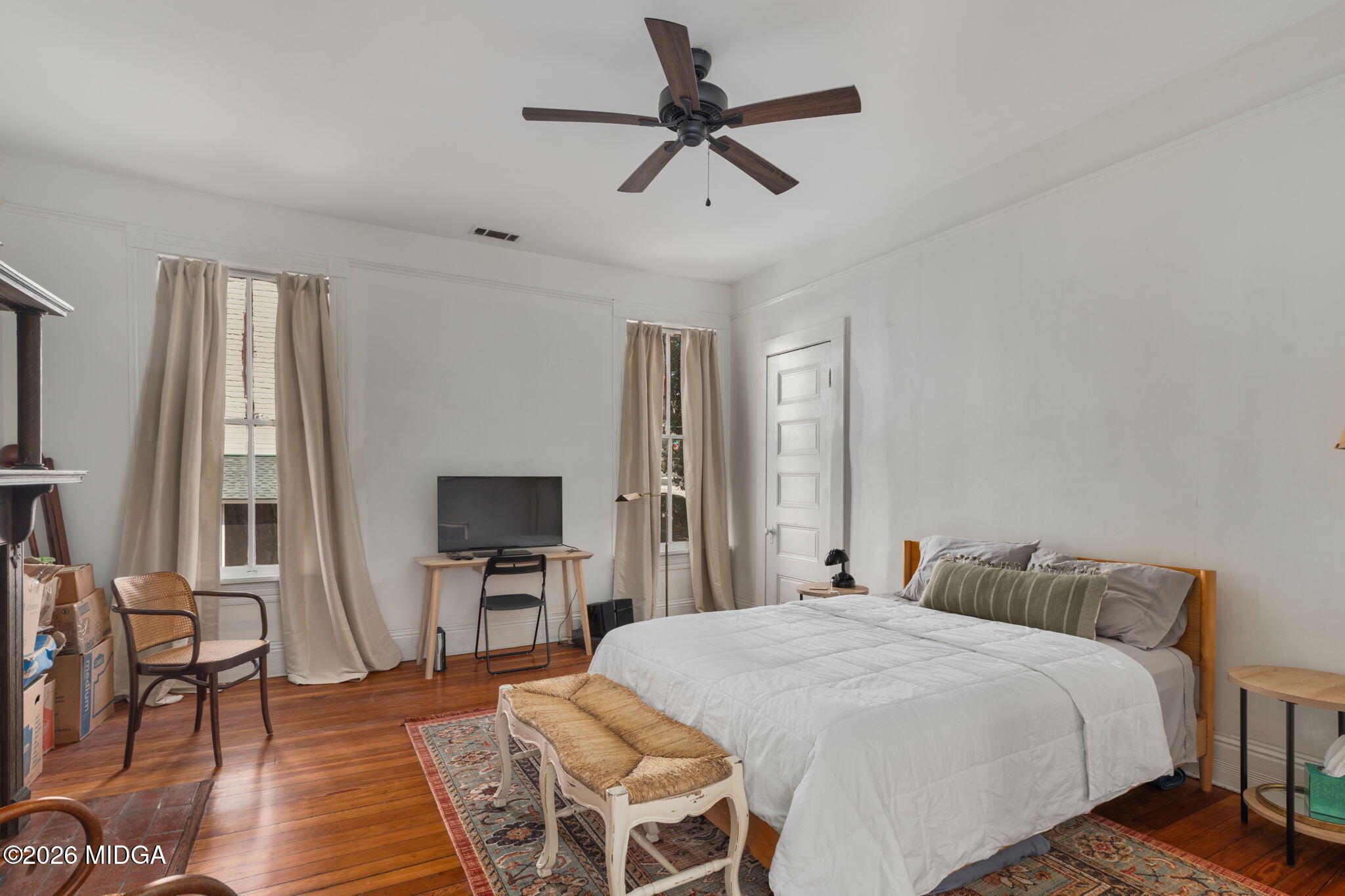 417 Orange Street Macon, GA 31201 - Photo 37 of 49 a bedroom with a bed and wooden floor
