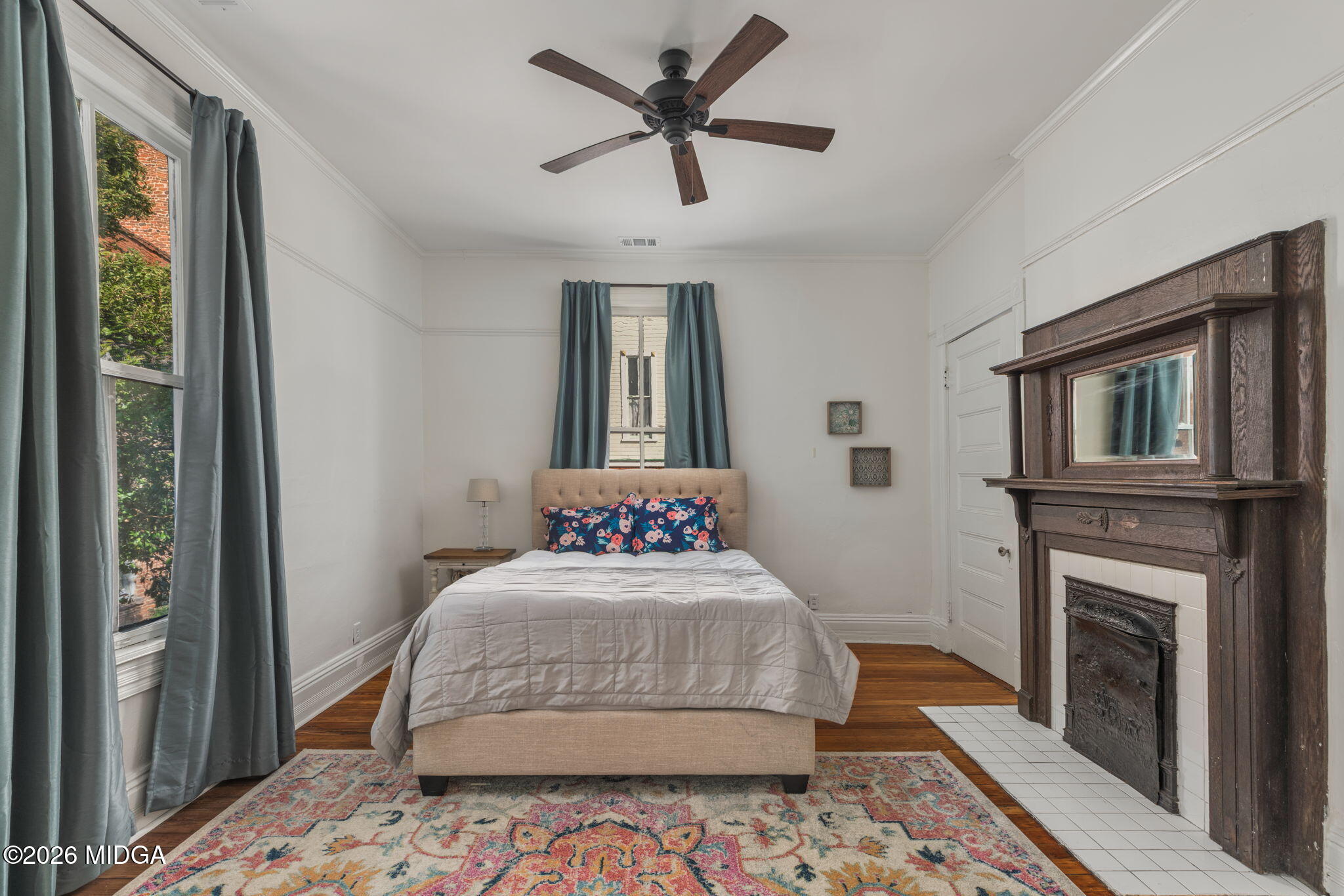 417 Orange Street Macon, GA 31201 - Photo 39 of 49 a bedroom with a bed and a fireplace