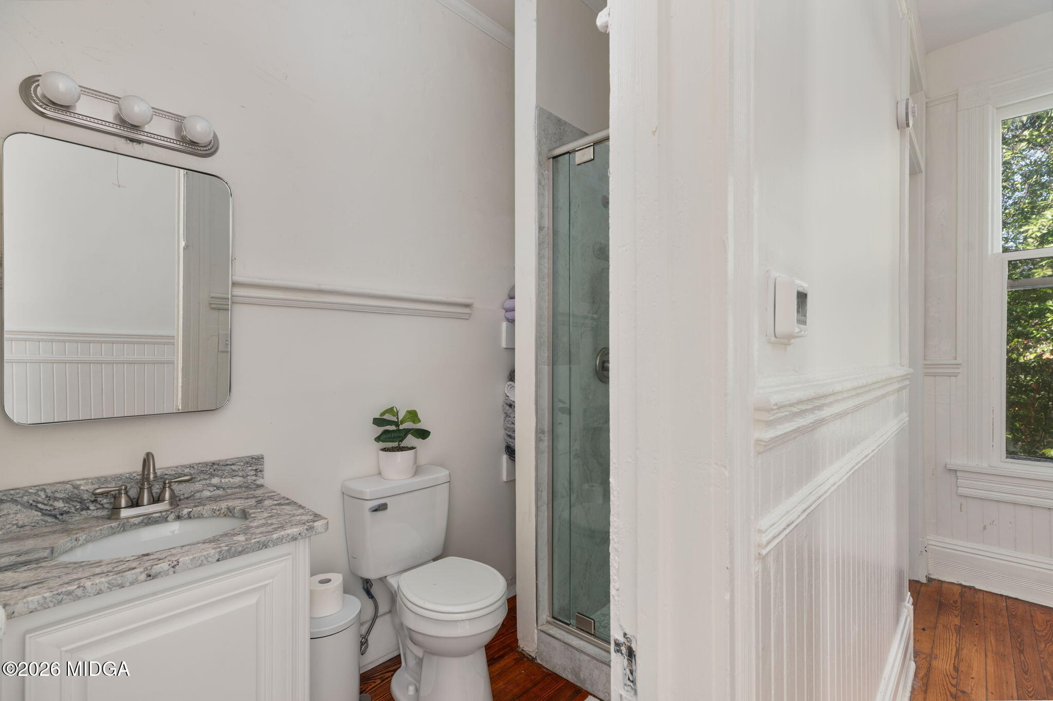 417 Orange Street Macon, GA 31201 - Photo 41 of 49 a bathroom with a granite countertop sink toilet and mirror