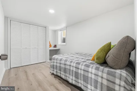 a bedroom with a bed and a chair