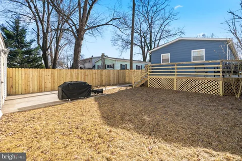a backyard of a house with wooden fence