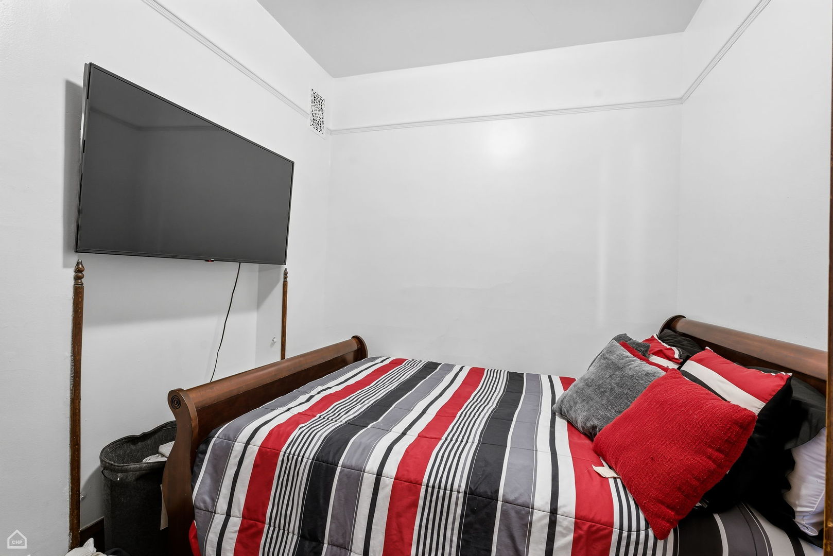 4736 South Prairie Avenue Chicago, IL 60615 - Photo 18 of 39 a bedroom with a bed and a flat screen tv