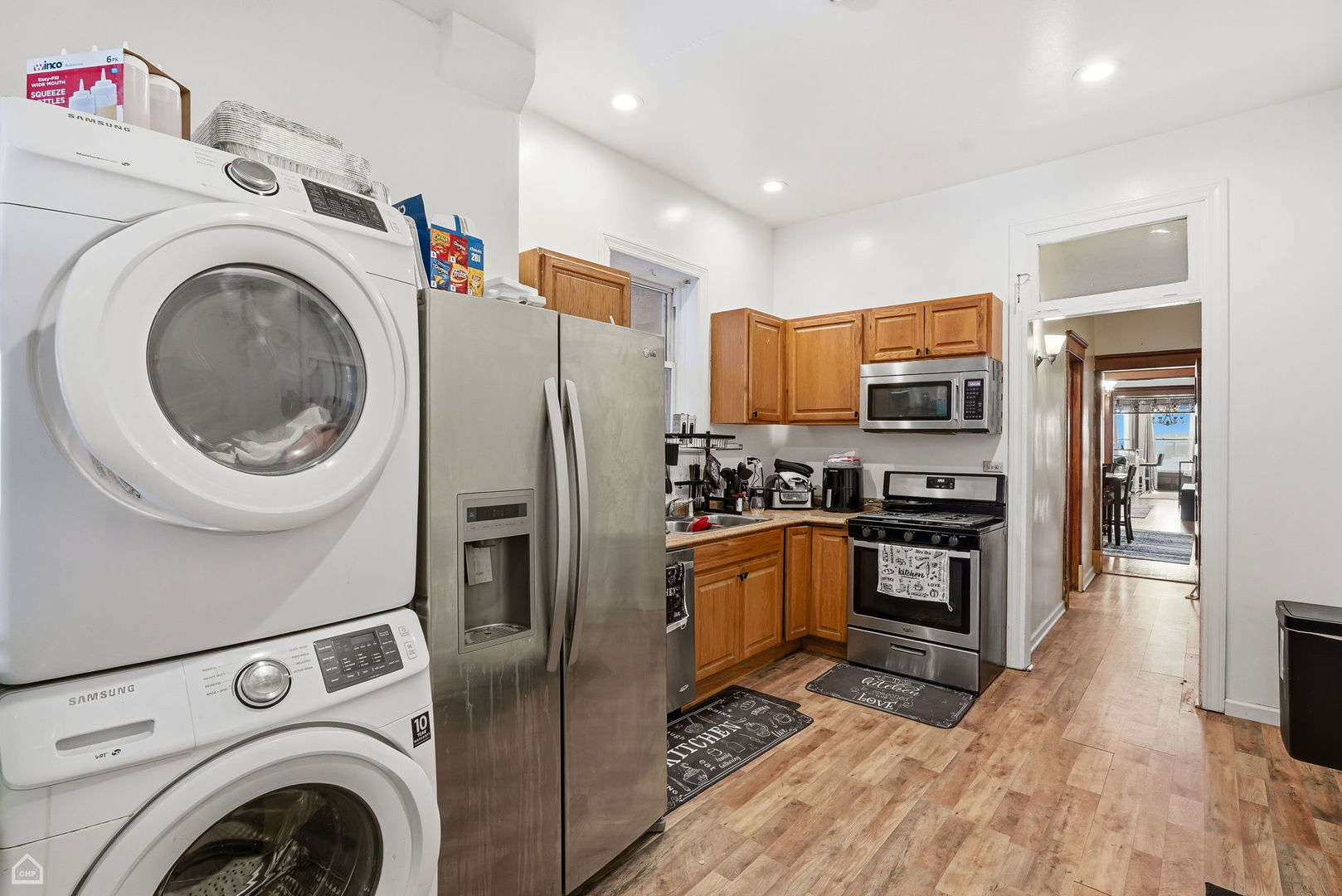 4736 South Prairie Avenue Chicago, IL 60615 - Photo 19 of 39 a kitchen with stainless steel appliances a refrigerator sink and cabinets