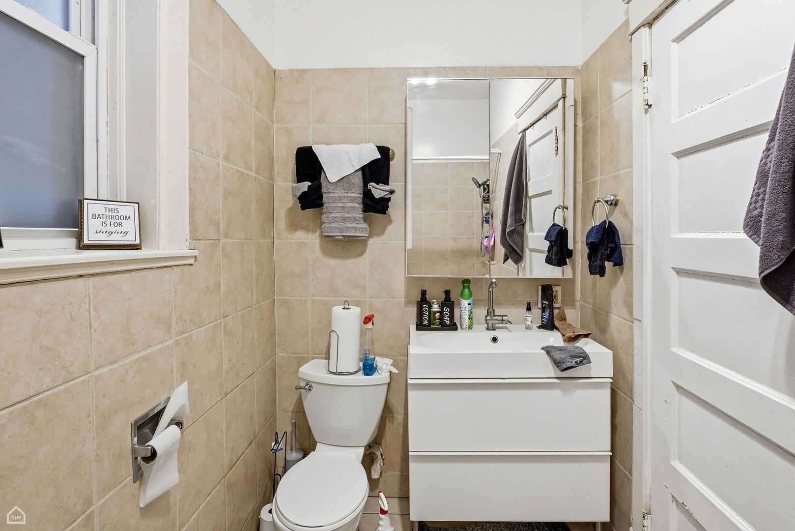 4736 South Prairie Avenue Chicago, IL 60615 - Photo 20 of 39 a bathroom with a toilet sink and mirror