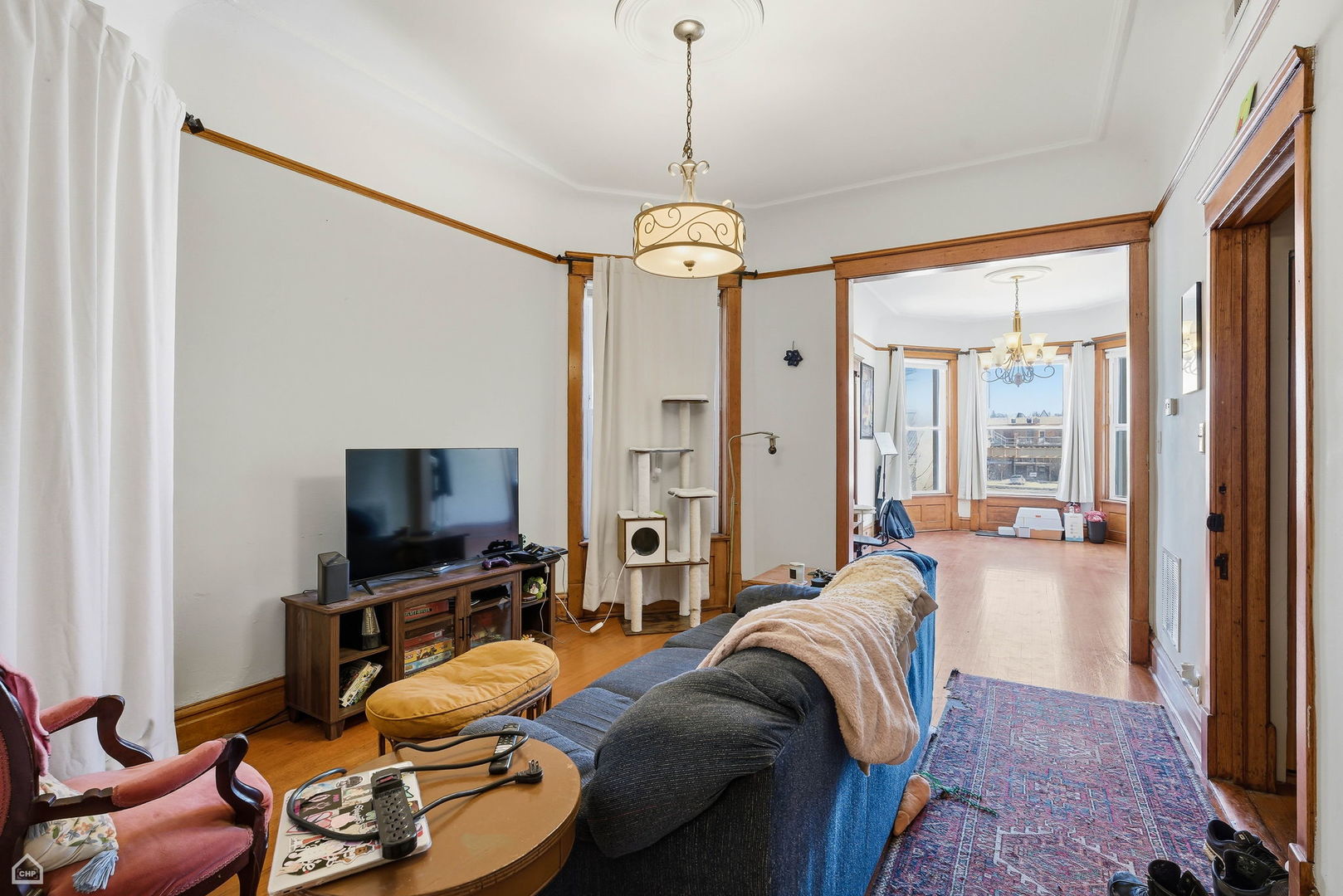 4736 South Prairie Avenue Chicago, IL 60615 - Photo 26 of 39 a living room with furniture a flat screen tv and a large window