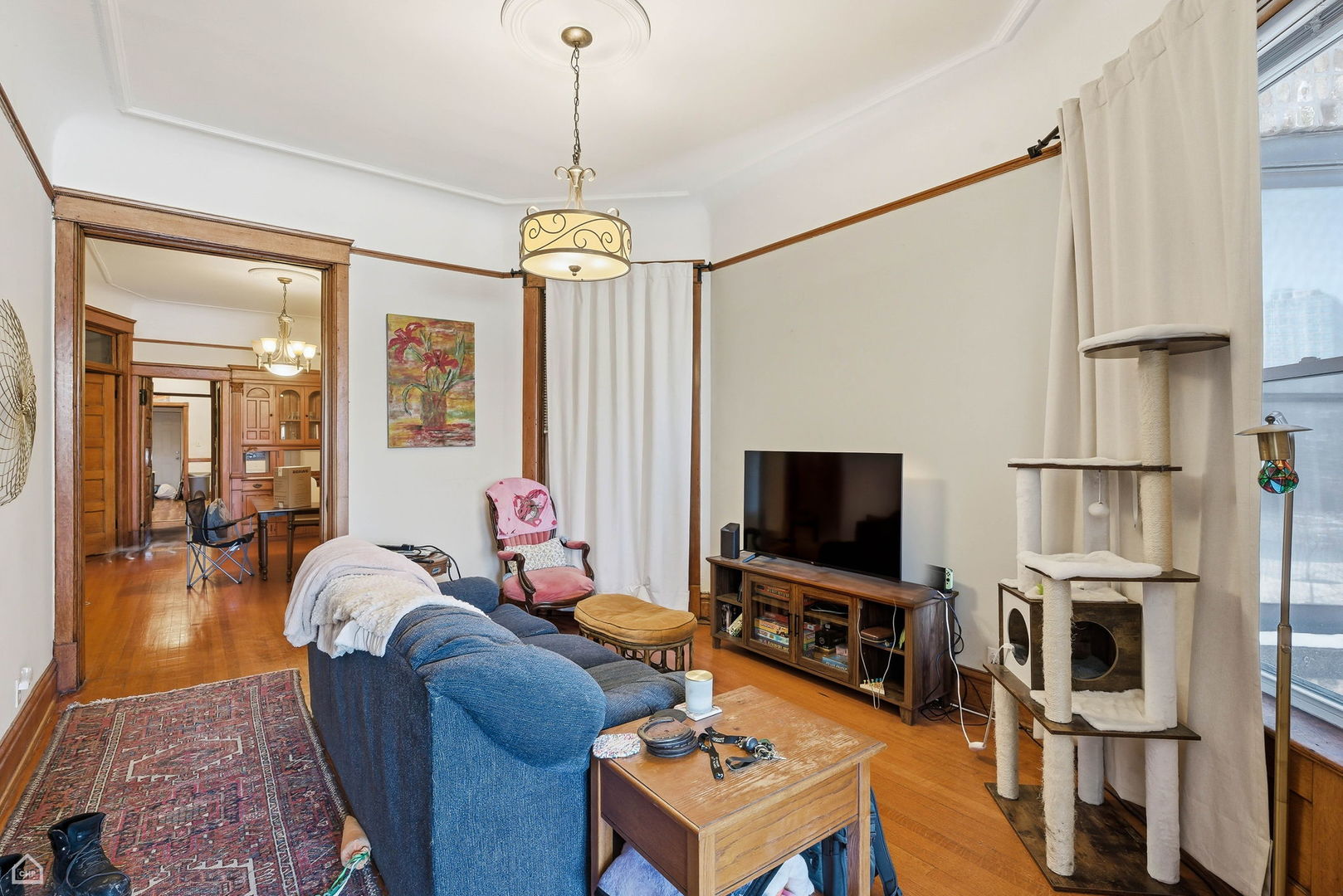 4736 South Prairie Avenue Chicago, IL 60615 - Photo 27 of 39 a living room with furniture a flat screen tv and a dining table
