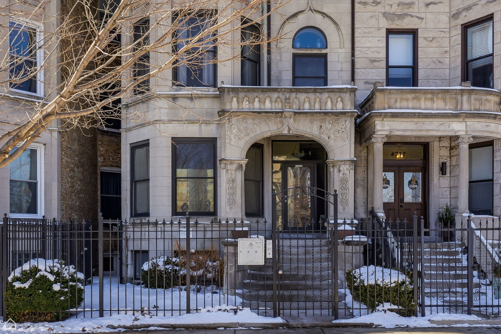 4736 South Prairie Avenue Chicago, IL 60615 - Photo 5 of 39 a front view of a house with potted plants