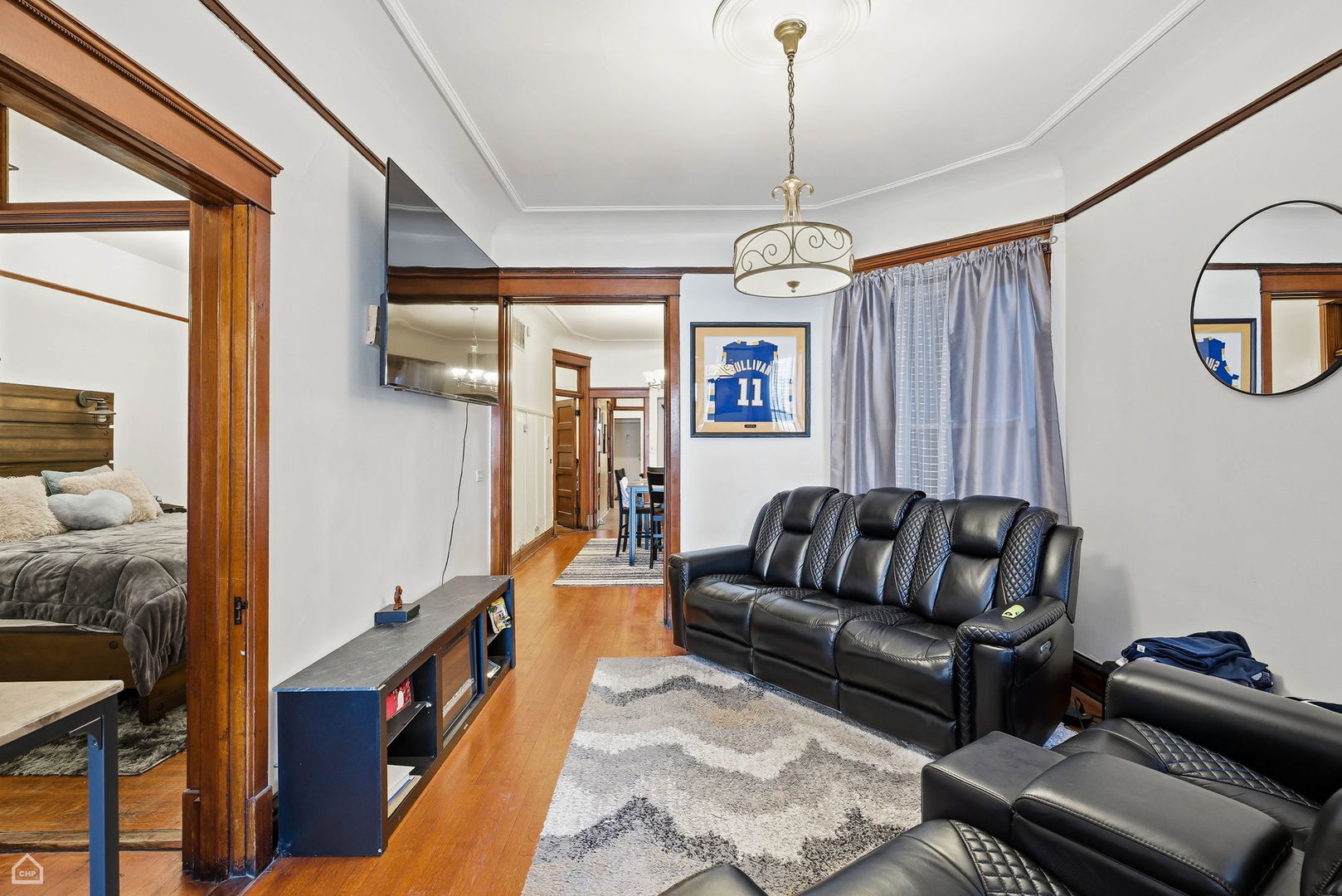 4736 South Prairie Avenue Chicago, IL 60615 - Photo 10 of 39 a living room with furniture ceiling fan and a wooden floor