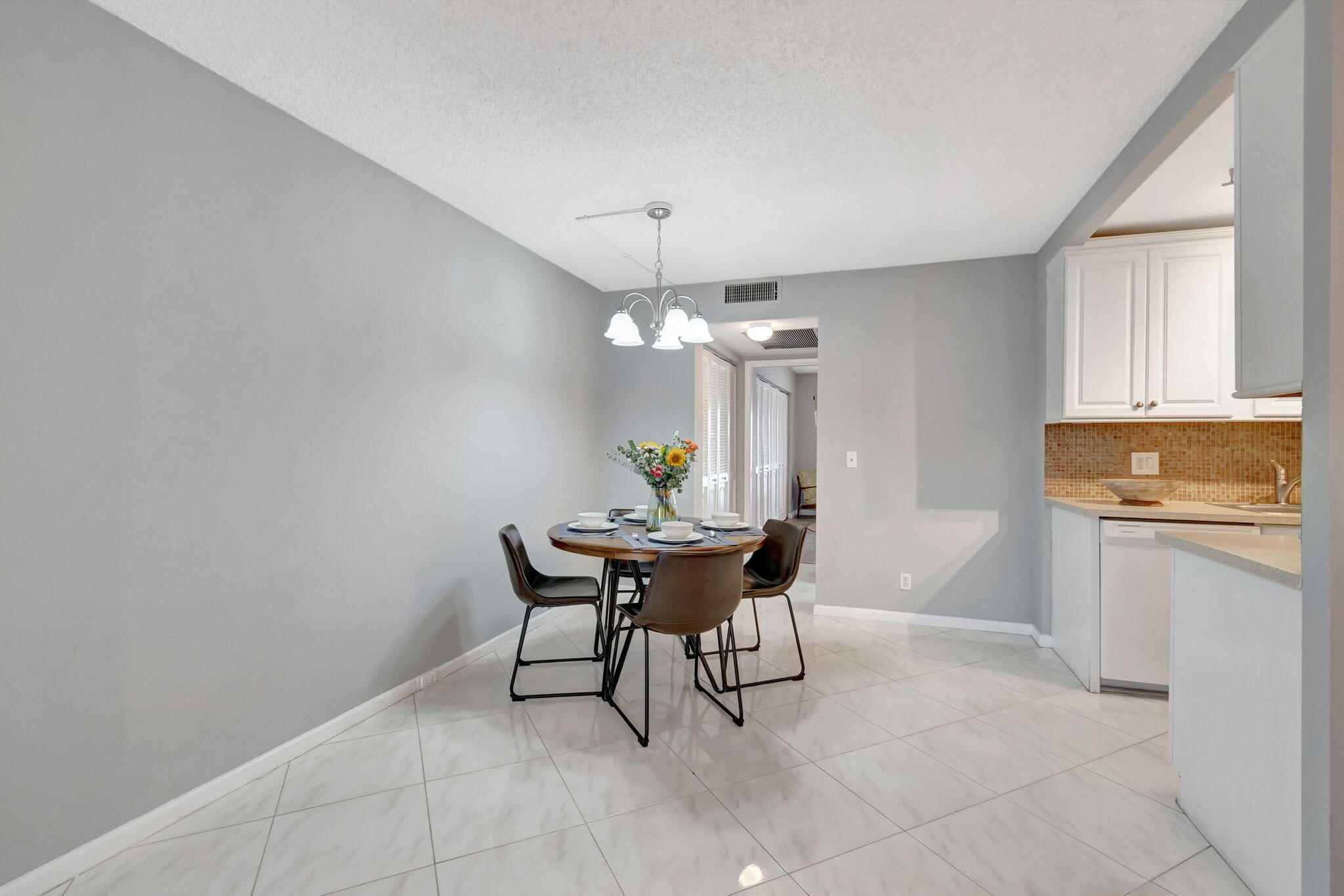 3031 Cornwall East Boca Raton, FL 33434 - Photo 6 of 84 a dining room with a table and chairs