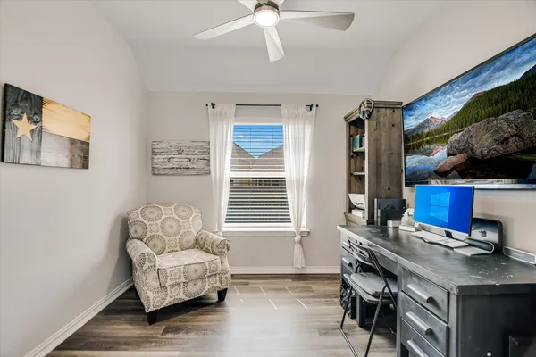 a kitchen with lots of counter top space and painting on the wall