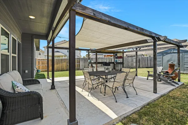 a bathroom with a granite countertop toilet sink and mirror