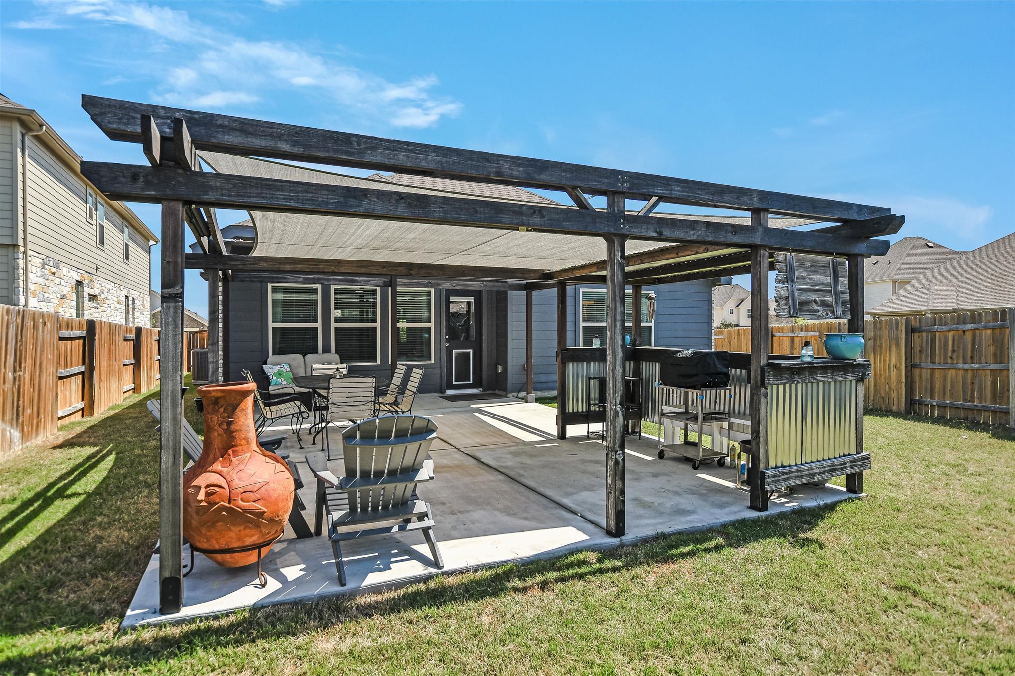 1101 Terrace View Drive Georgetown, TX 78628 - Photo 18 of 20 a view of a patio with table and chairs near a barbeque