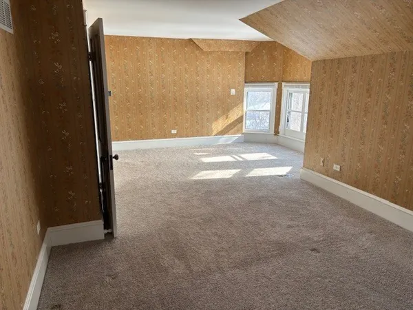 a view of a big room with closet and windows