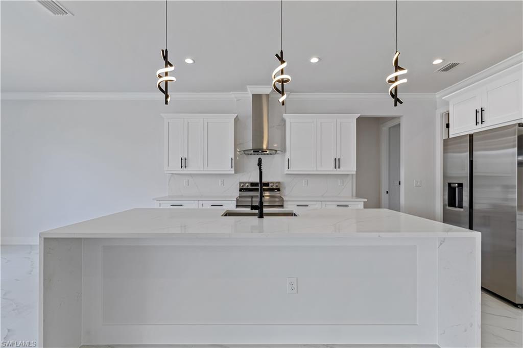 3397 14th Avenue Southeast Naples, FL 34117 - Photo 13 of 28 a view of a kitchen with a sink and refrigerator