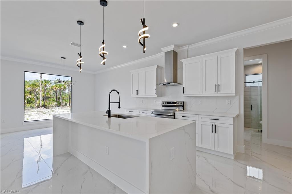 3397 14th Avenue Southeast Naples, FL 34117 - Photo 14 of 28 a kitchen with kitchen island white cabinets and white appliances