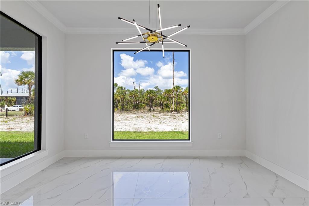 3397 14th Avenue Southeast Naples, FL 34117 - Photo 16 of 28 a view of a livingroom with a window and a ceiling fan
