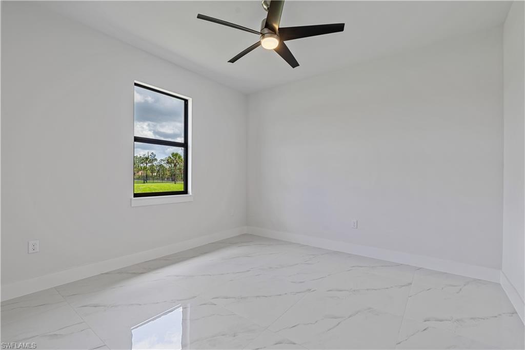 3397 14th Avenue Southeast Naples, FL 34117 - Photo 18 of 28 an empty room with a window and a ceiling fan