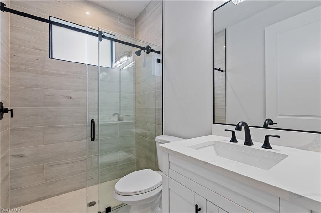 3397 14th Avenue Southeast Naples, FL 34117 - Photo 19 of 28 a bathroom with a sink a toilet and shower