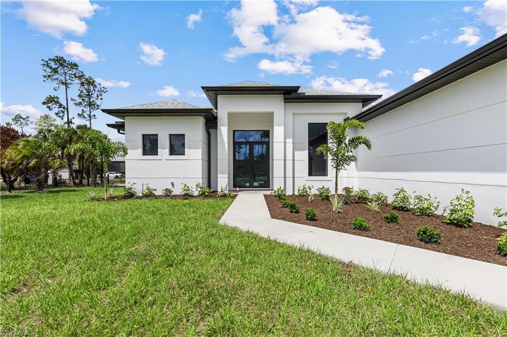 3397 14th Avenue Southeast Naples, FL 34117 - Photo 2 of 28 a front view of a house with garden