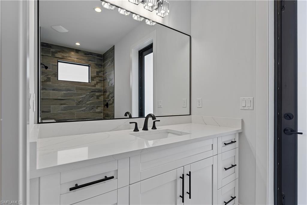 3397 14th Avenue Southeast Naples, FL 34117 - Photo 21 of 28 a bathroom with a sink and a mirror