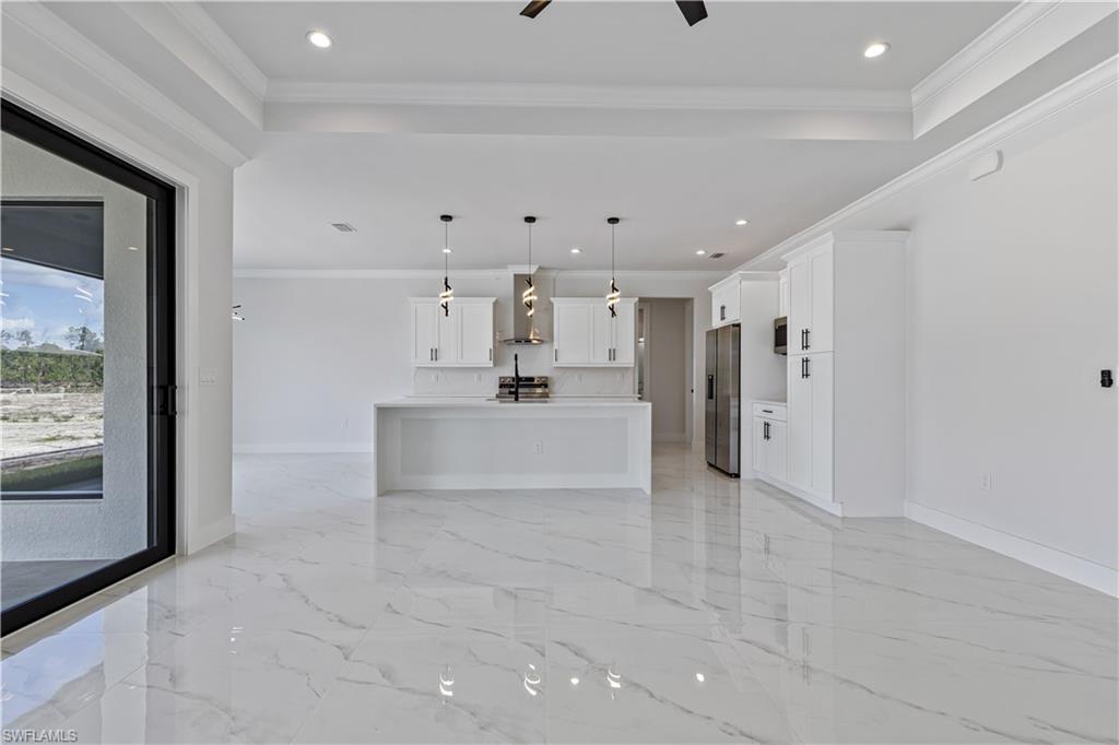 3397 14th Avenue Southeast Naples, FL 34117 - Photo 10 of 28 a big room with chandelier and windows