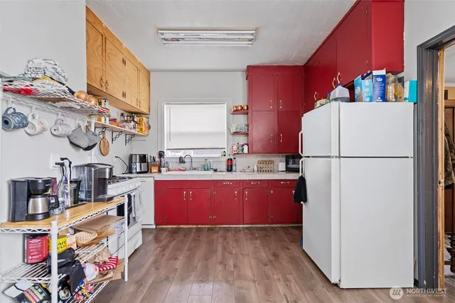 a kitchen with stainless steel appliances granite countertop a refrigerator a stove a sink and a microwave