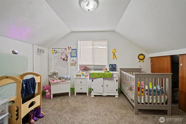 a bedroom with furniture and a baby crib