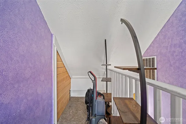 a view of a hallway with furniture