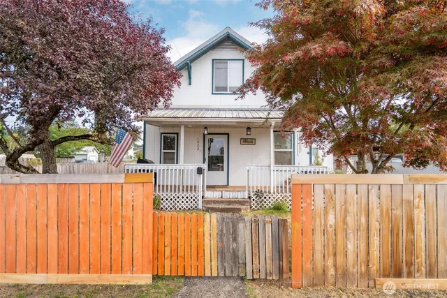 a front view of a house with a garden