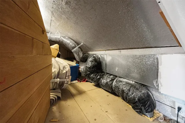 a bed with white sheets and pillows on it