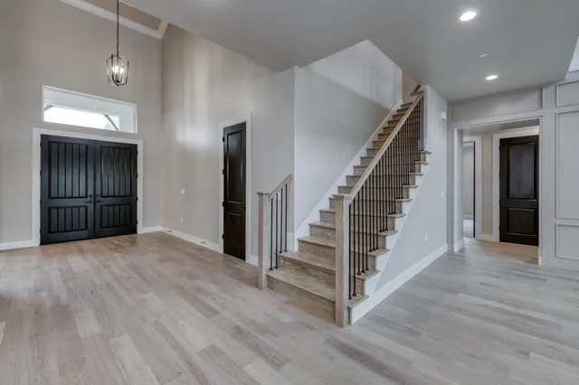 an empty room with a window and a ceiling fan