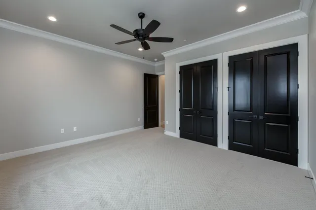 a view of an empty room with a ceiling fan