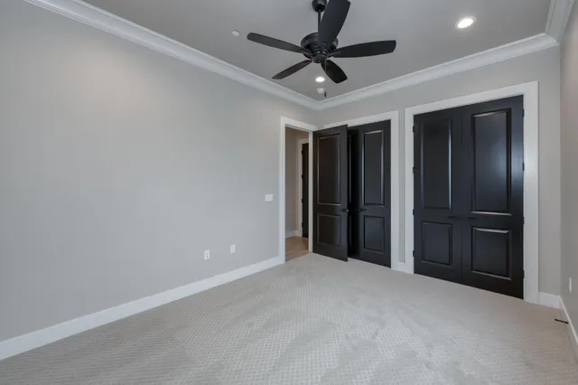 a view of walk in closet with empty racks