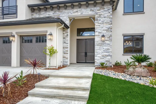 a front view of a house with a garden