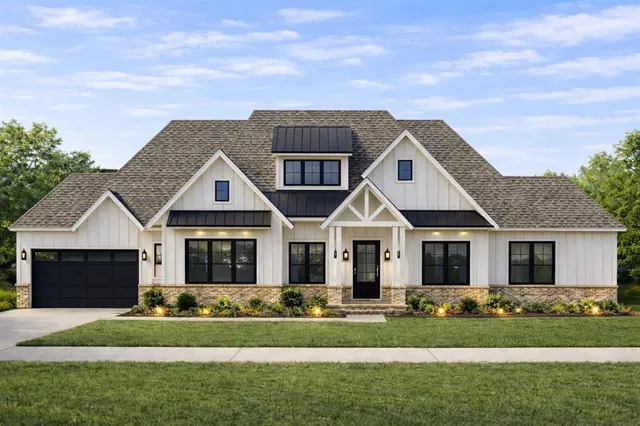 a front view of a house with a garden and yard