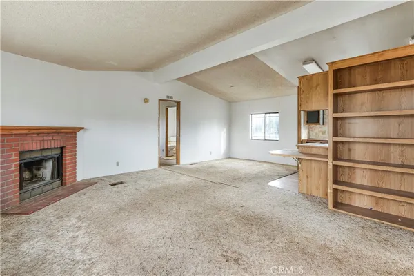 a view of empty room with a fireplace and cabinet