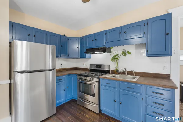 a white refrigerator freezer sitting in a kitchen