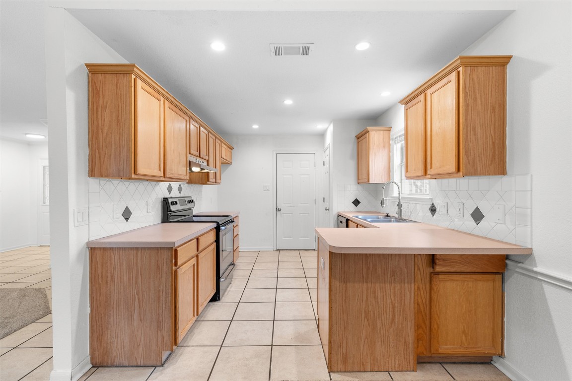 2602 Peach Tree Lane Cedar Park, TX 78613 - Photo 5 of 16 a kitchen with a sink stove and cabinets