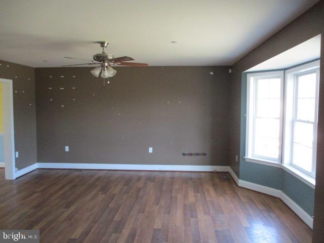 3102 Roger Road Baltimore, MD 21219 - Photo 3 of 16 wooden floor in an empty room with a window