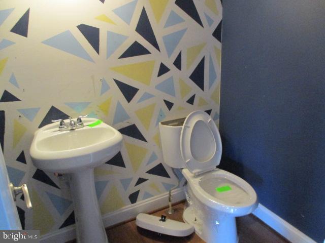 3102 Roger Road Baltimore, MD 21219 - Photo 7 of 16 a bathroom with a toilet sink and mirror