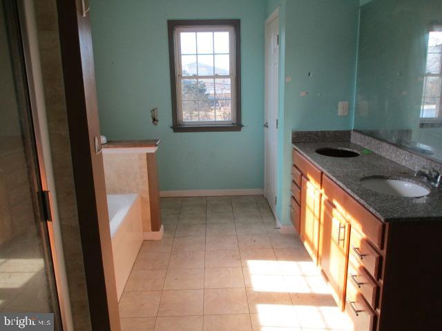 3102 Roger Road Baltimore, MD 21219 - Photo 9 of 16 a bathroom with a granite countertop sink and a mirror