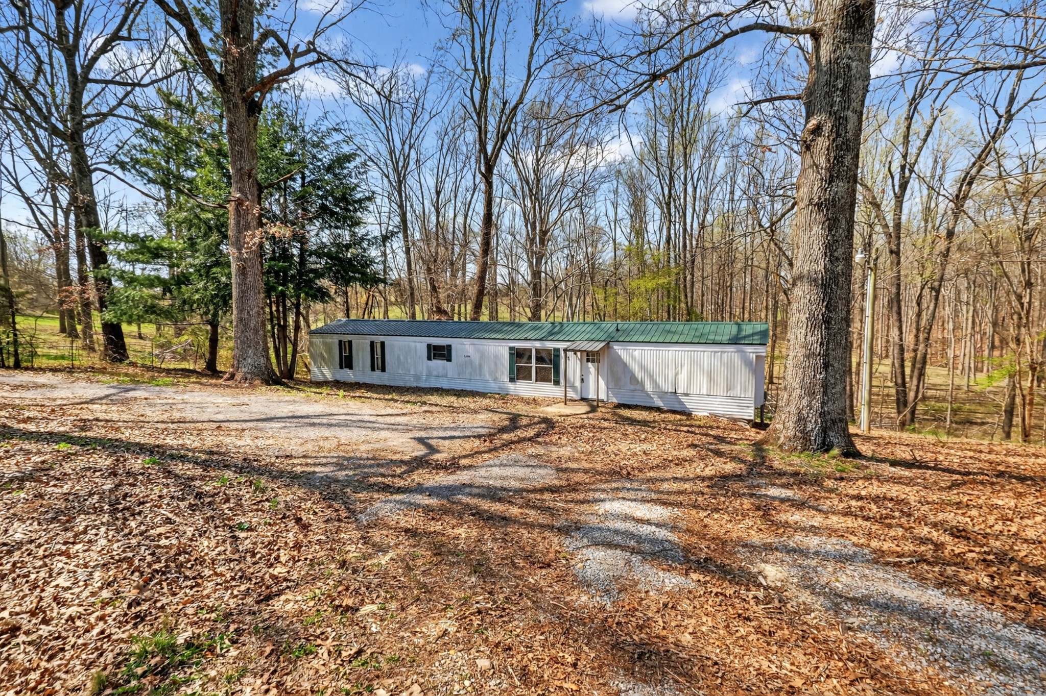 285 George Akins Road Westmoreland, TN 37186 - Photo 23 of 26 a house with trees in front of it