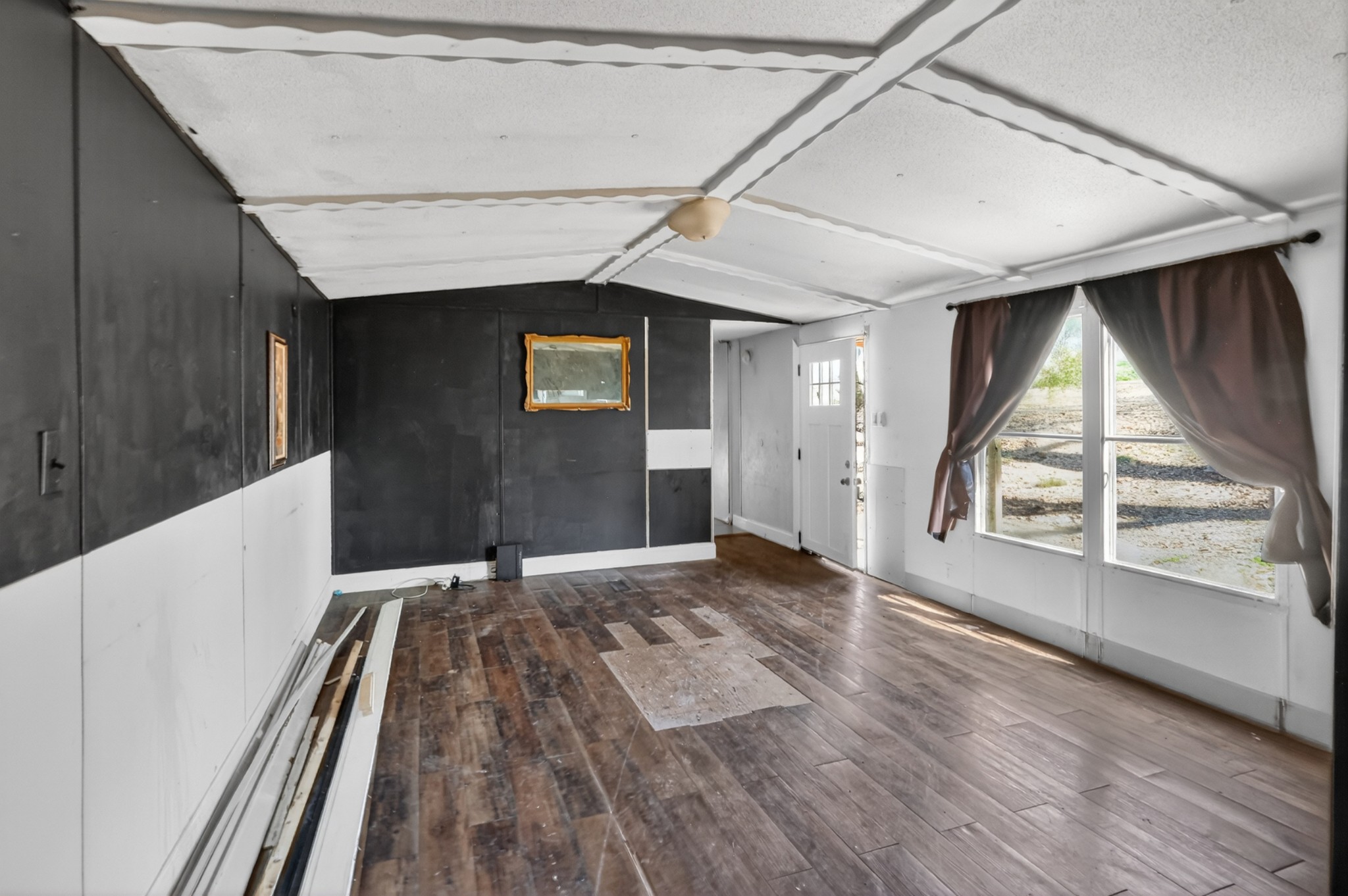 285 George Akins Road Westmoreland, TN 37186 - Photo 5 of 26 a view of an empty room with wooden floor and a window