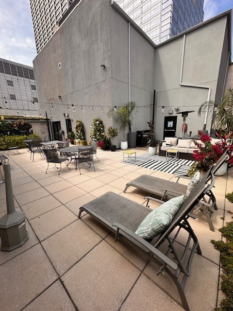 8 West Monroe Street, Unit 1206 Chicago, IL 60603 - Photo 11 of 12 a view of kitchen with stainless steel appliances kitchen island granite countertop a table chairs in it and wooden floors