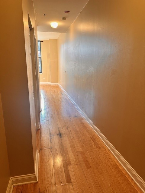 8 West Monroe Street, Unit 1206 Chicago, IL 60603 - Photo 7 of 12 a view of hallway with a large window and wooden floor